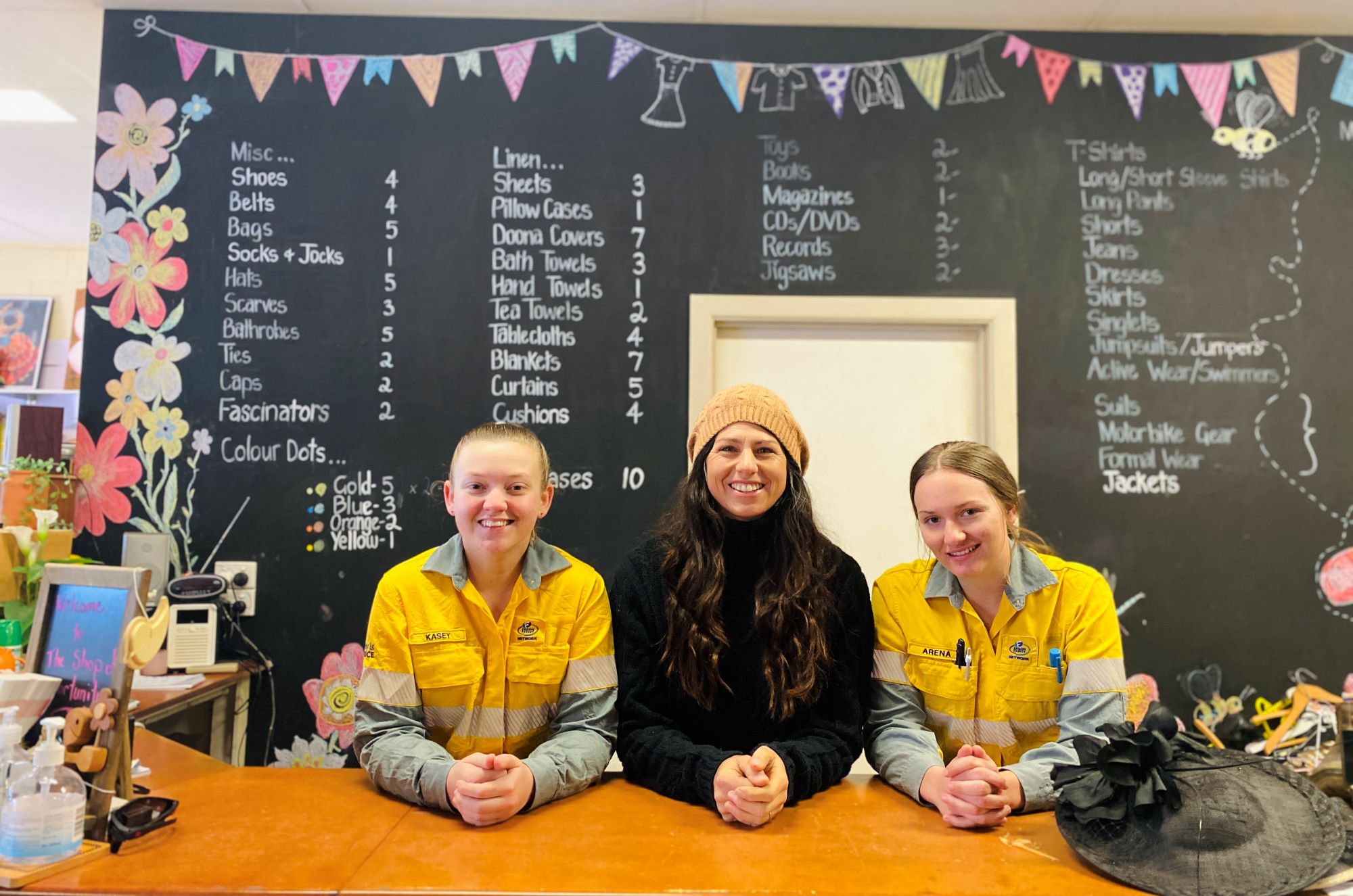 Two workers with a customer as part of community fund