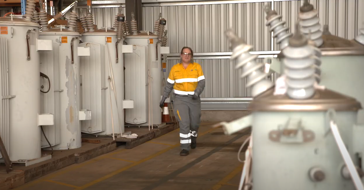 Female crew member walking through substation