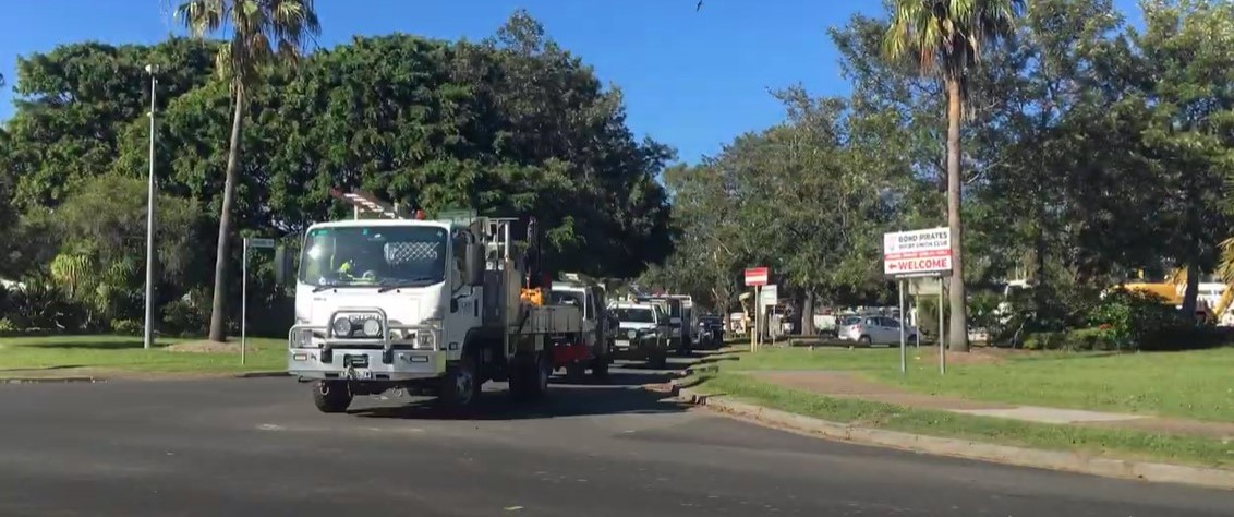 A number of trucks at an intersection merging onto the main road at Burleigh Heads