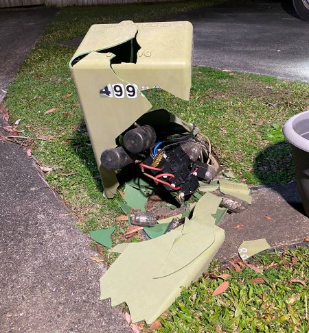 A broken green pillar box