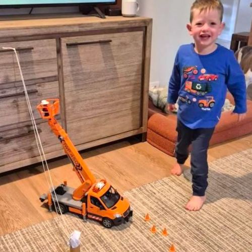 3 year old Parker playing in living room with bucket truck toy