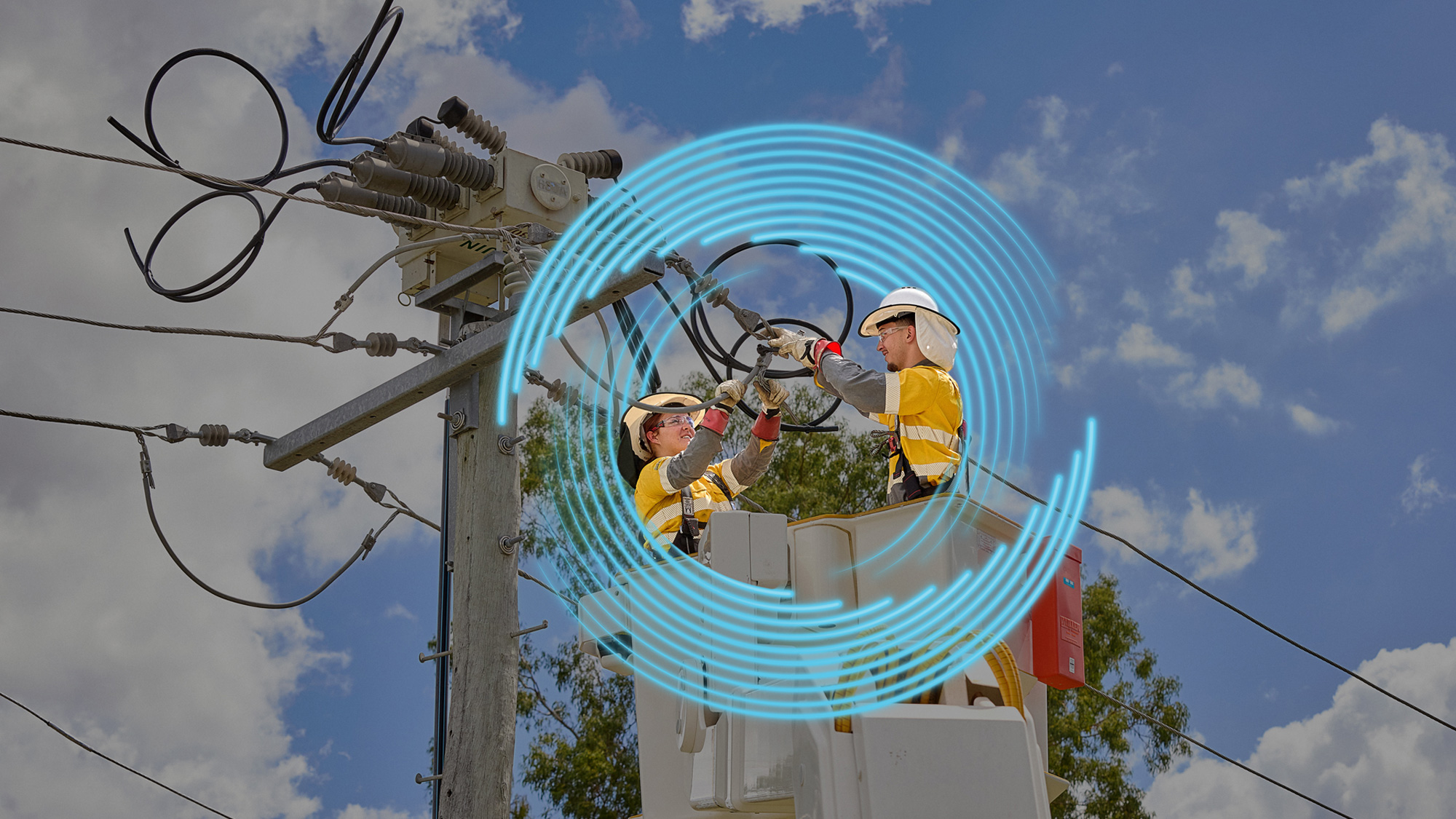 Field crew working on power lines in a cherry picker bucket