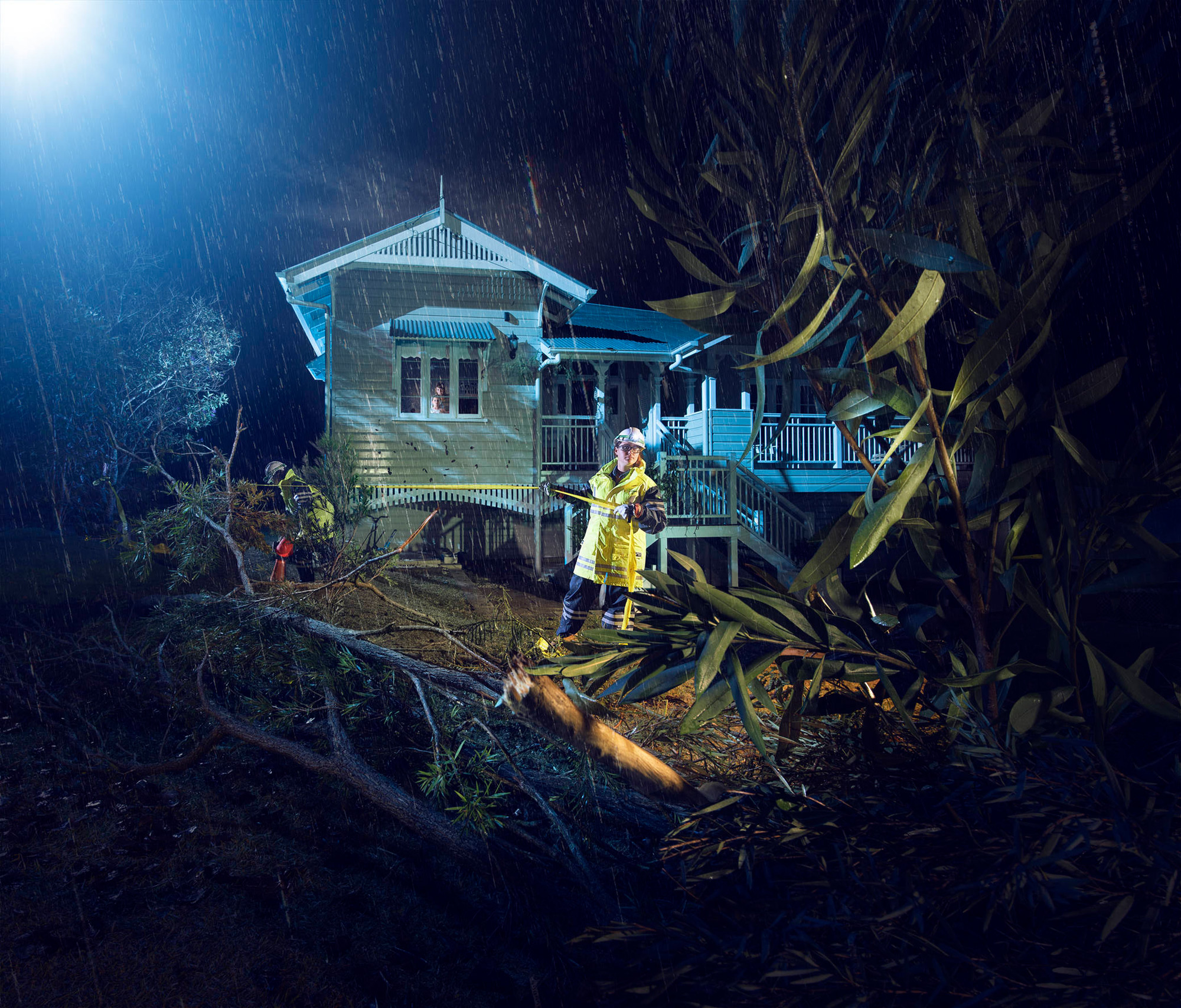 Storm with fallen trees and field crew in front of house