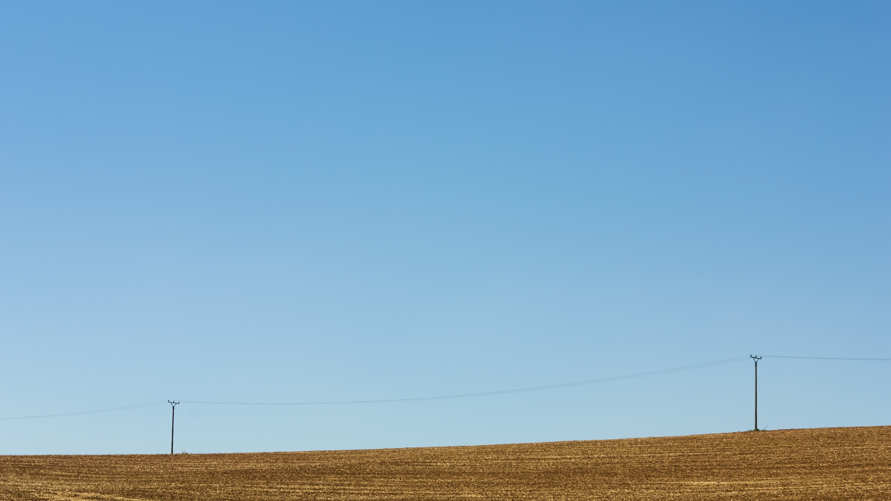 Powerline traversing through farm property.