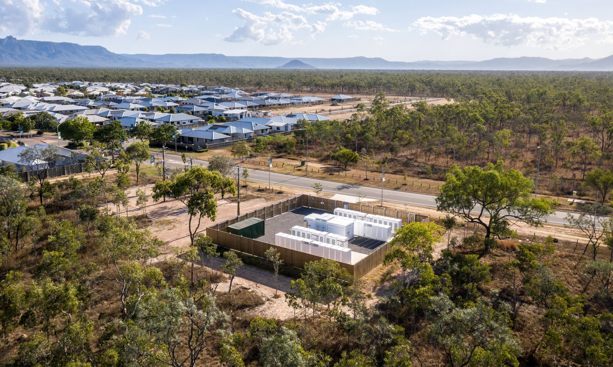 Network connected batteries with residential houses in the background