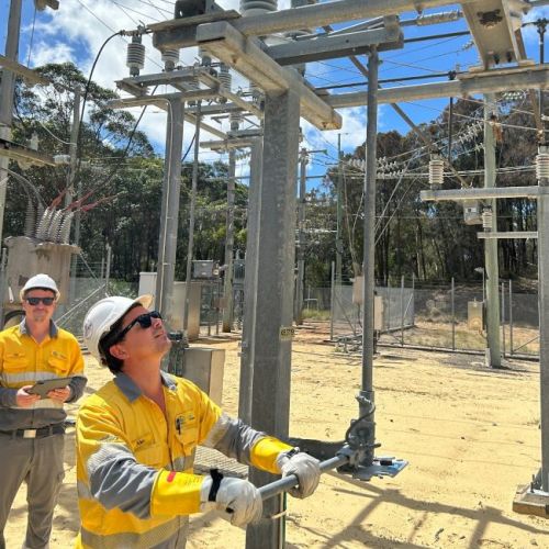 Two crew members inside a substation at Stradbroke Island