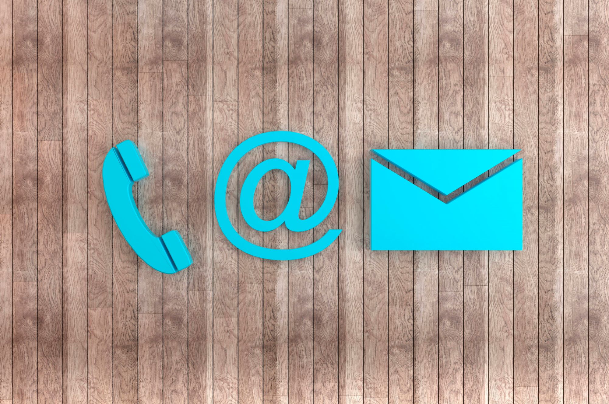 Blue phone email letter icons on a wooden background