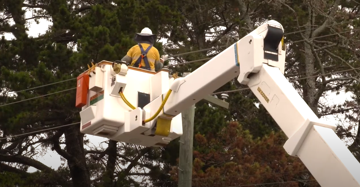 Crew member in a bucket working on powerlines