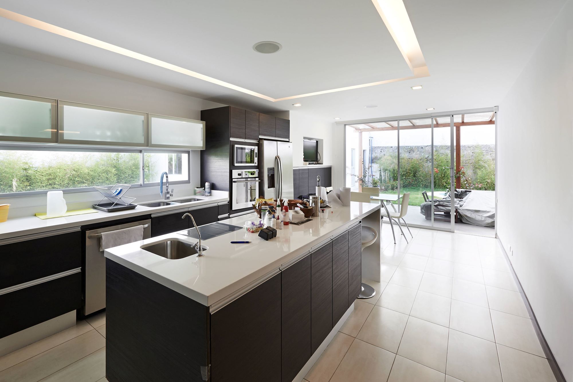 A kitchen filled with kitchen appliances such as microwave and refrigerator