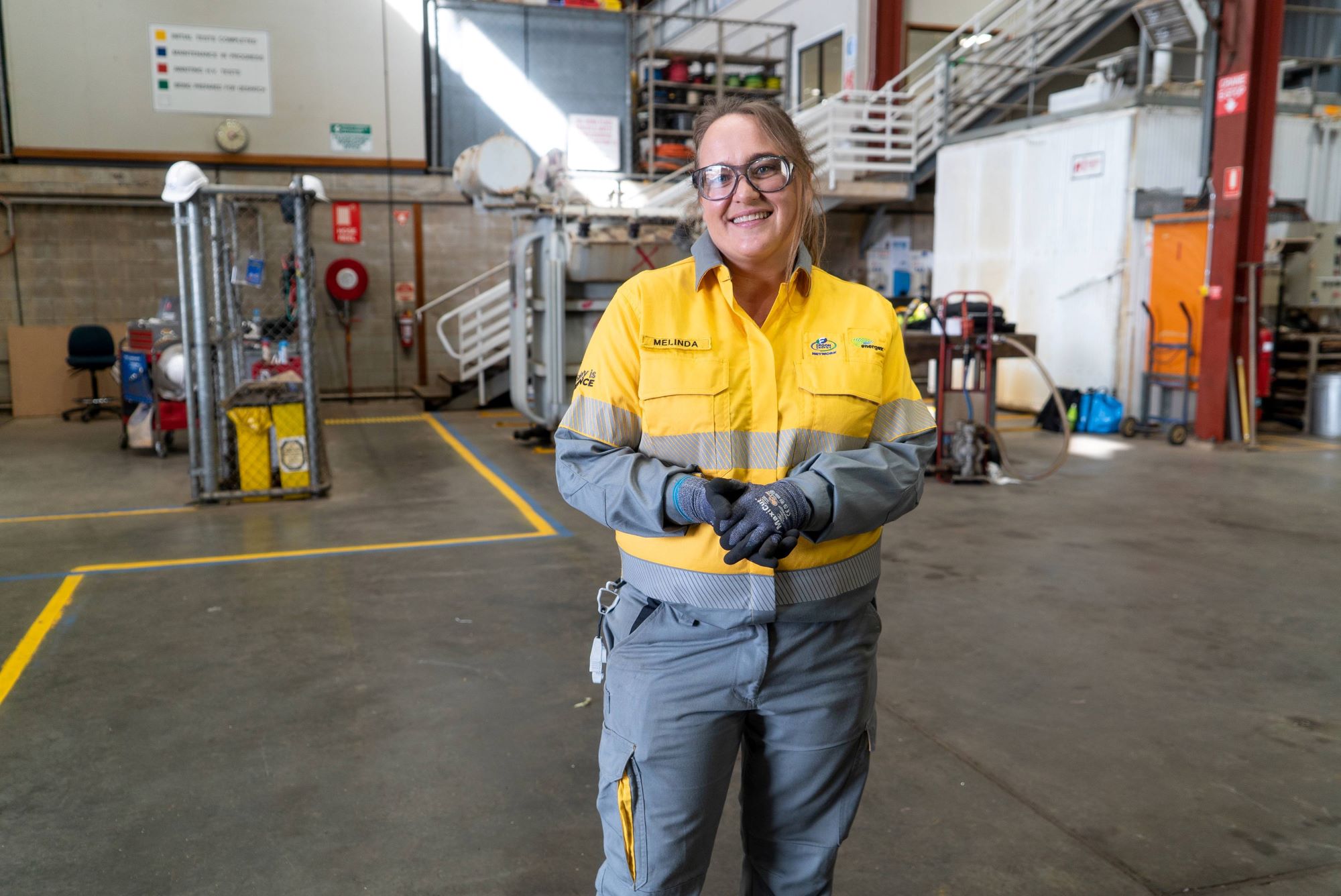 Female apprentice standing in the middle of a warehouse