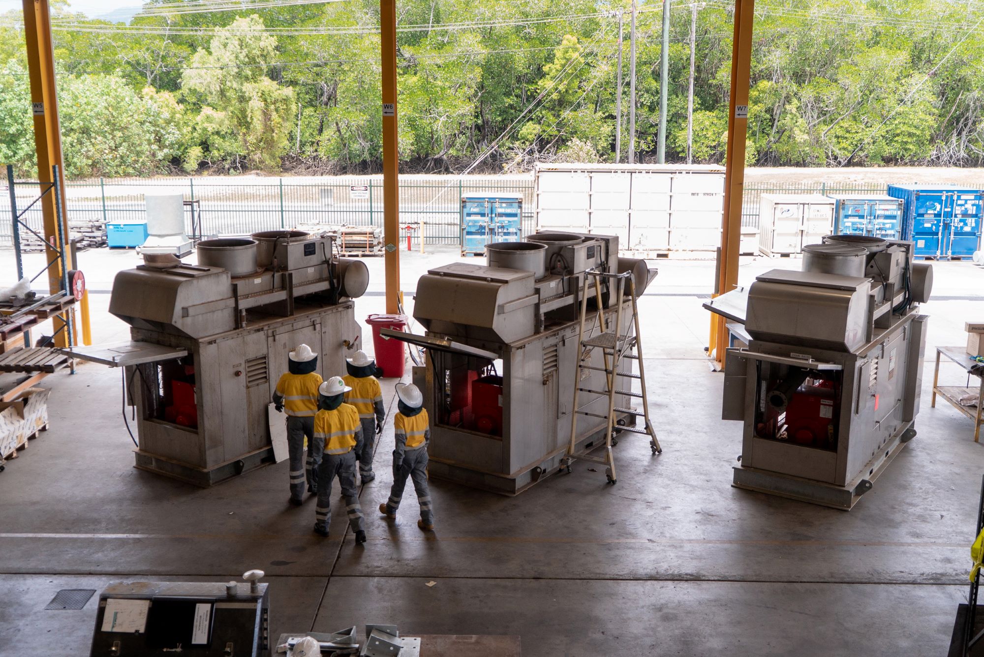 Workers walking through manufacturing warehouse