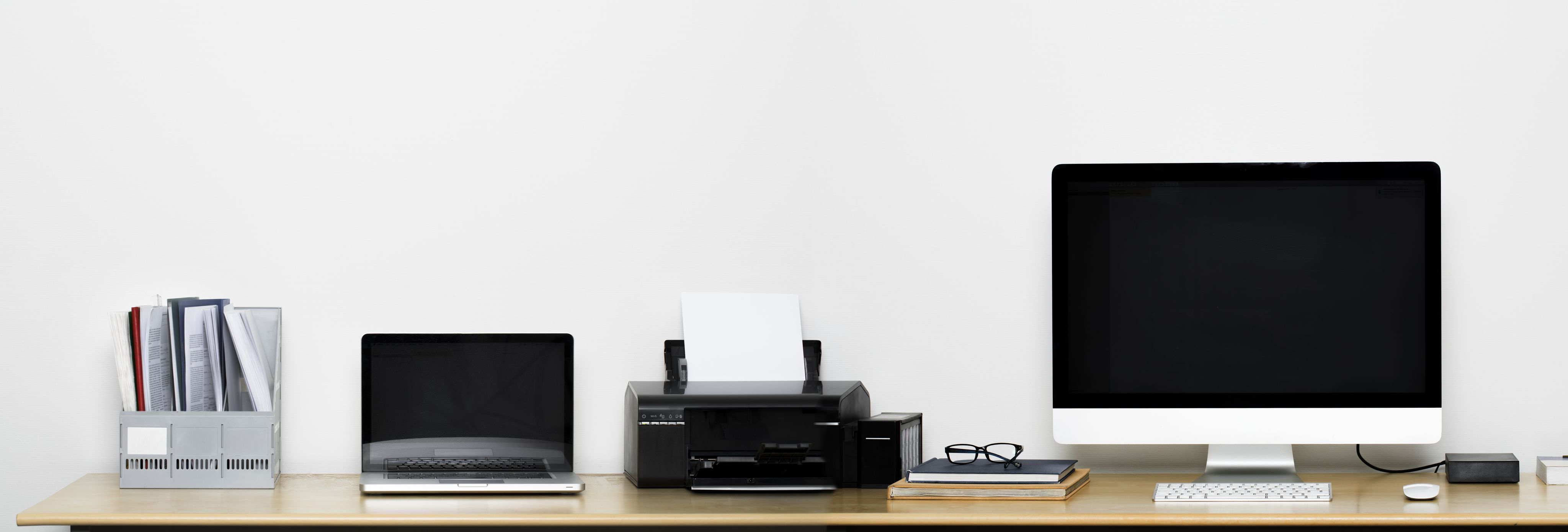 office desk with laptop, computer and printer