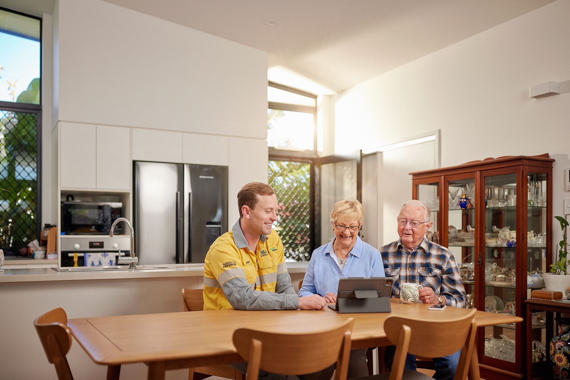 Field crew talking to customers at the kitchen table