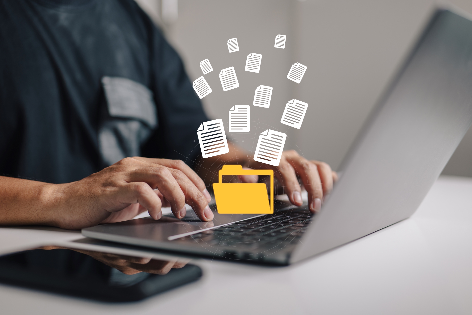 Hands typing on laptop with document folder icon in yellow in the middle